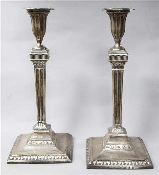 A pair of George III silver candlesticks, by Sutton & Bult, London, 1782, (both repaired), 30.9cm.